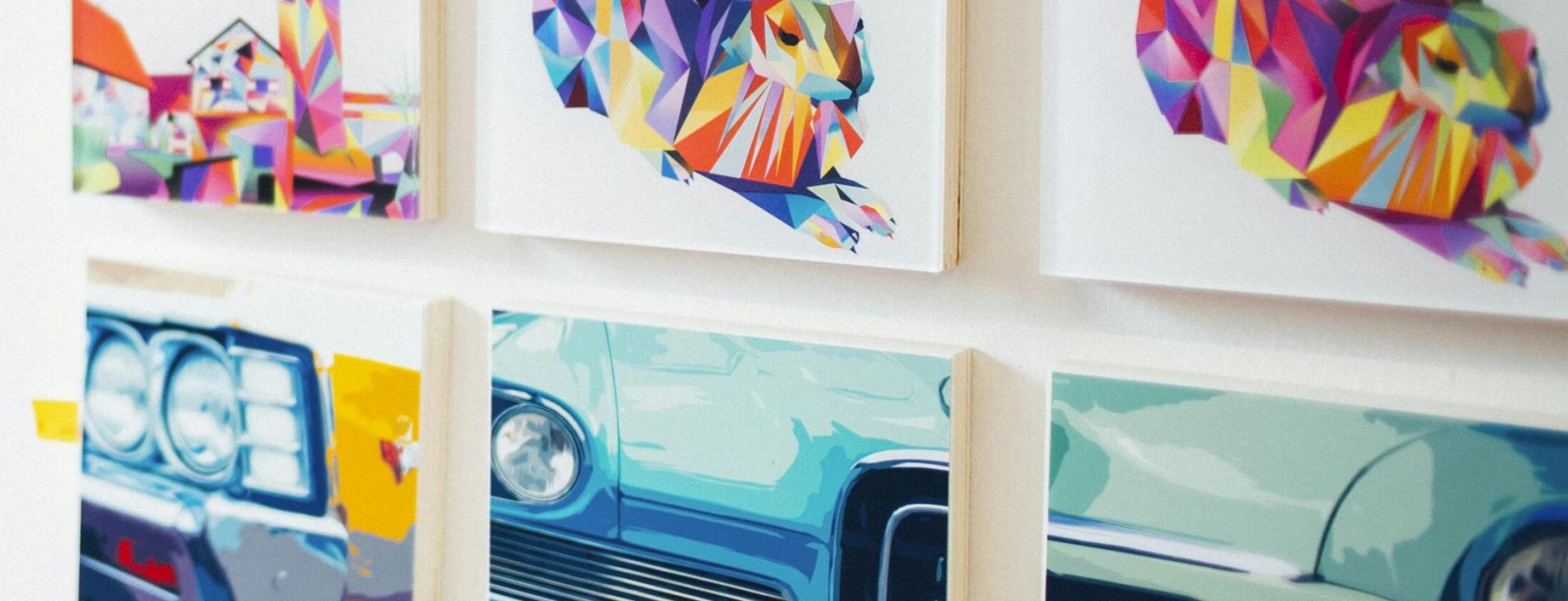 Colorful artwork showcased in a modern gallery setting with people browsing.